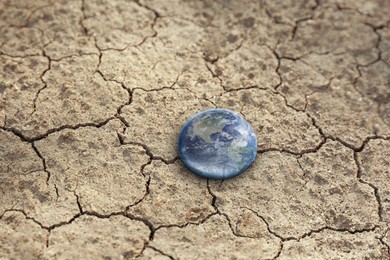 Image of Save environment. Drop with Earth on dry cracked land, closeup