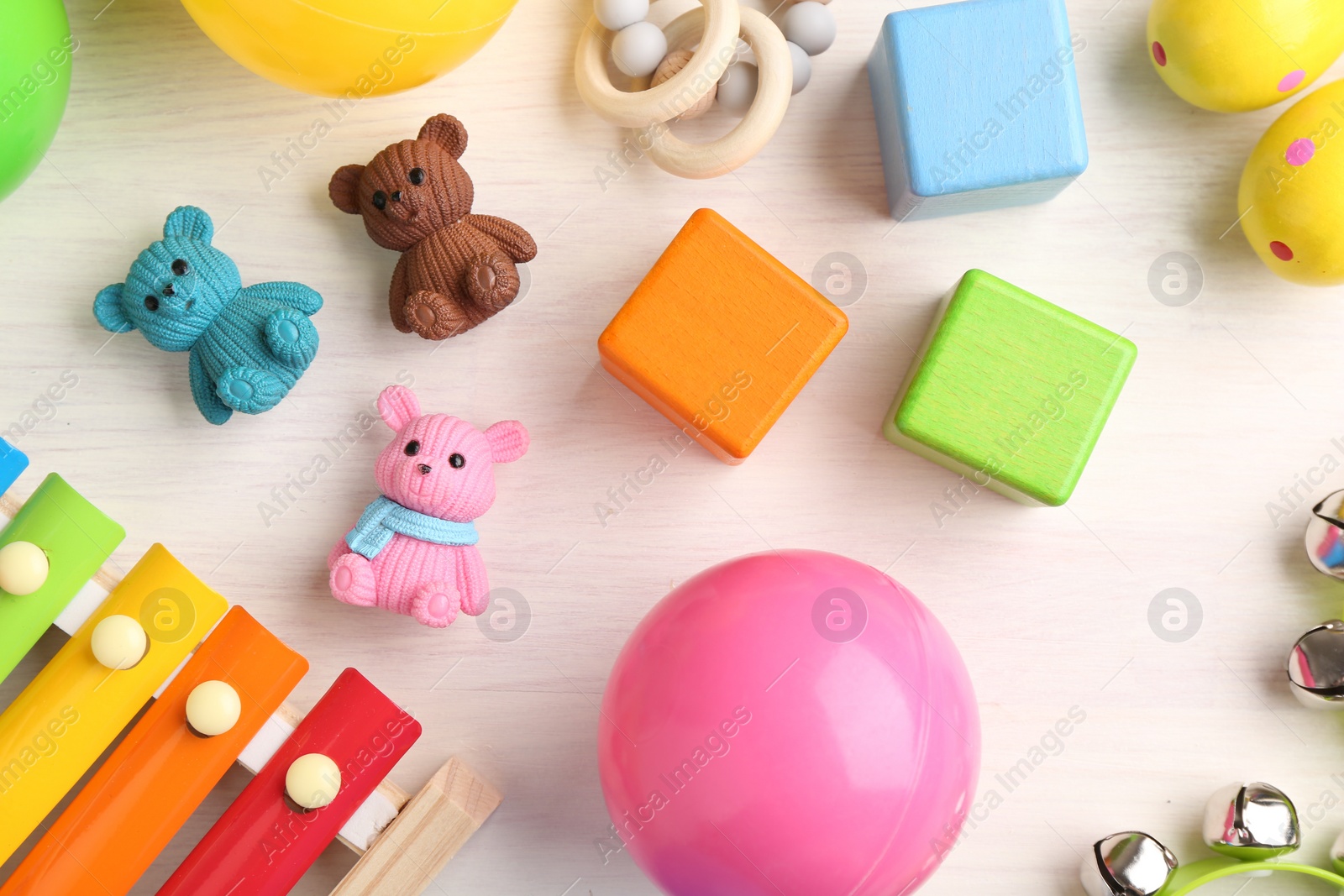 Photo of Baby song concept. Wooden xylophone and toys on table, flat lay