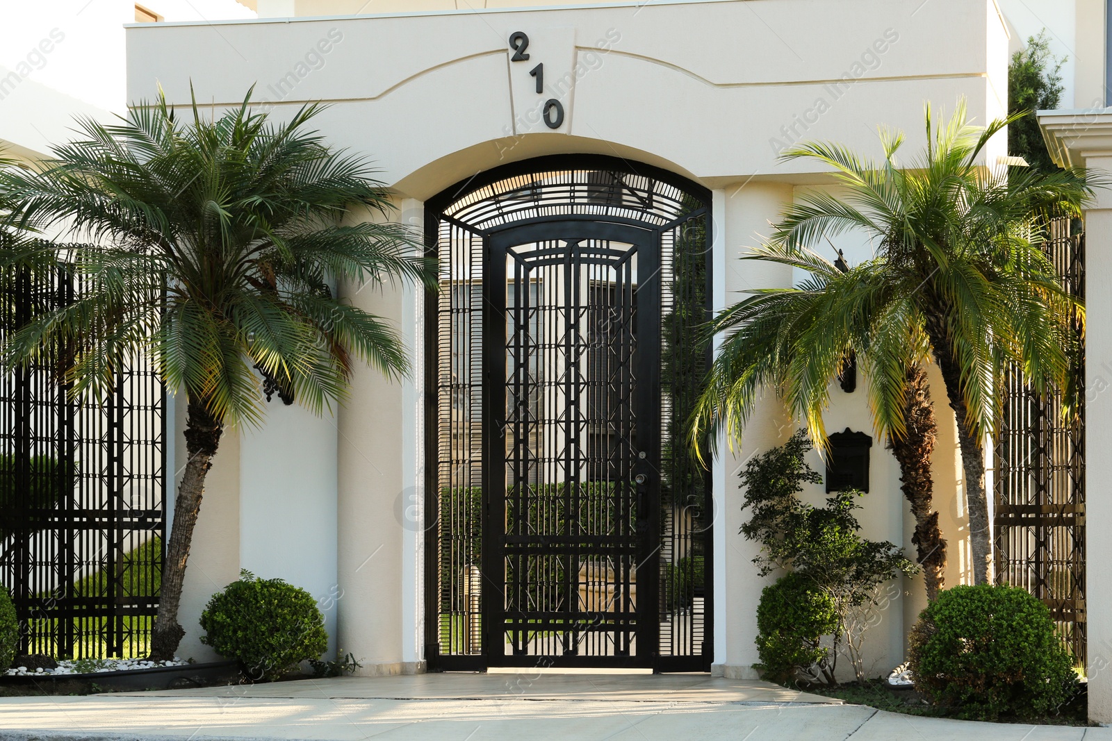 Photo of Closed metal door and fence outdoors on summer day