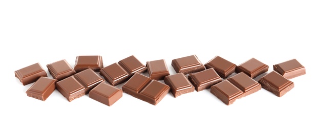 Photo of Pieces of tasty milk chocolate on white background