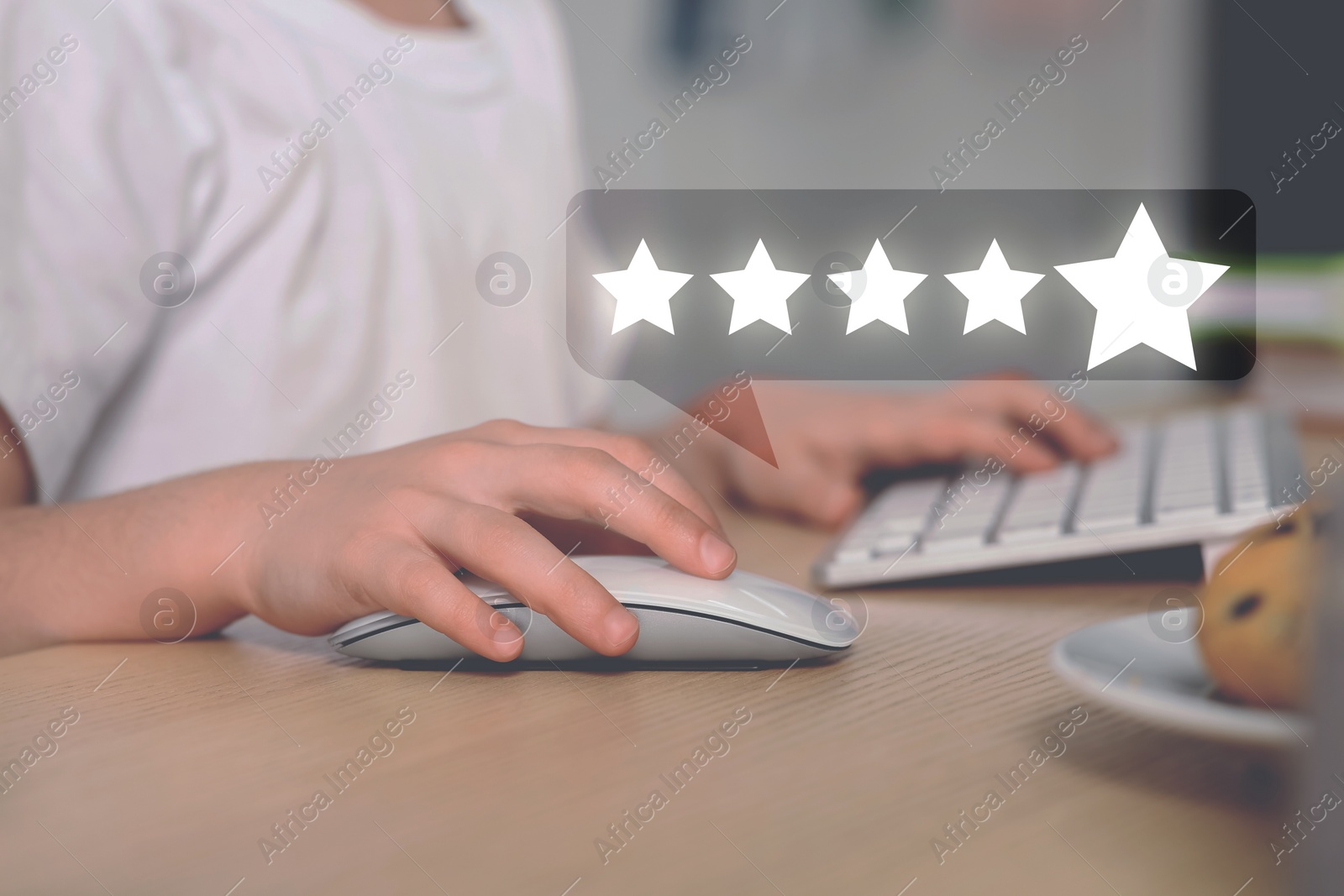 Image of Woman leaving service feedback using laptop at table, closeup. Stars near device