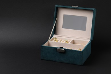 Photo of Jewelry box with many different accessories on dark gray background, space for text