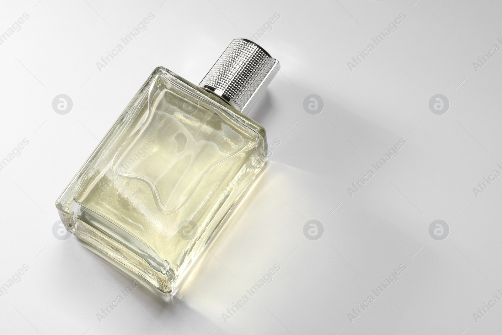 Photo of Luxury men`s perfume in bottle on white background, above view. Space for text