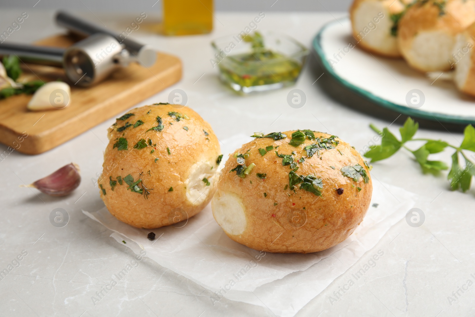 Photo of Traditional Ukrainian bread (Pampushky) with garlic on light table