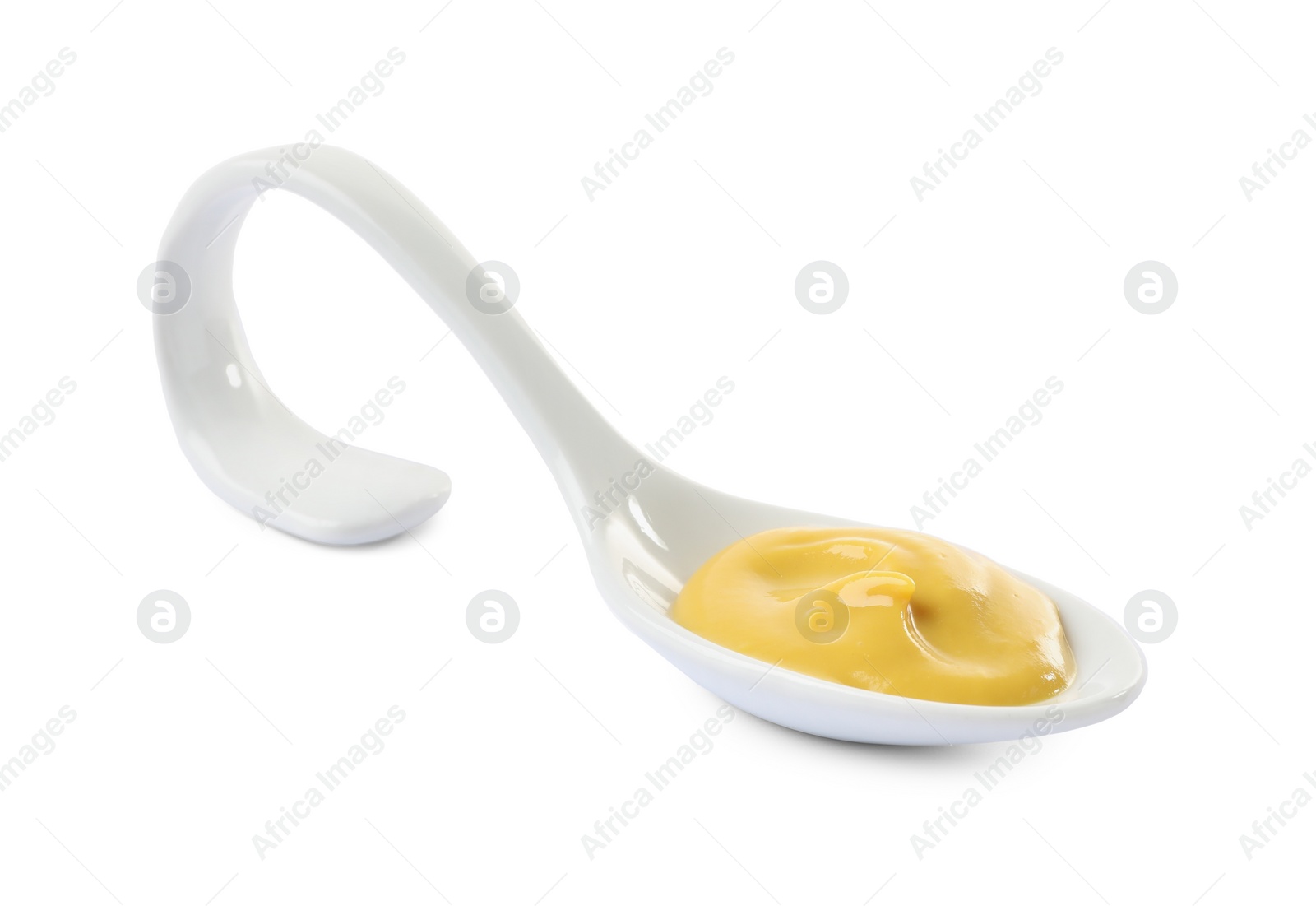 Photo of Mustard in ceramic serving spoon isolated on white