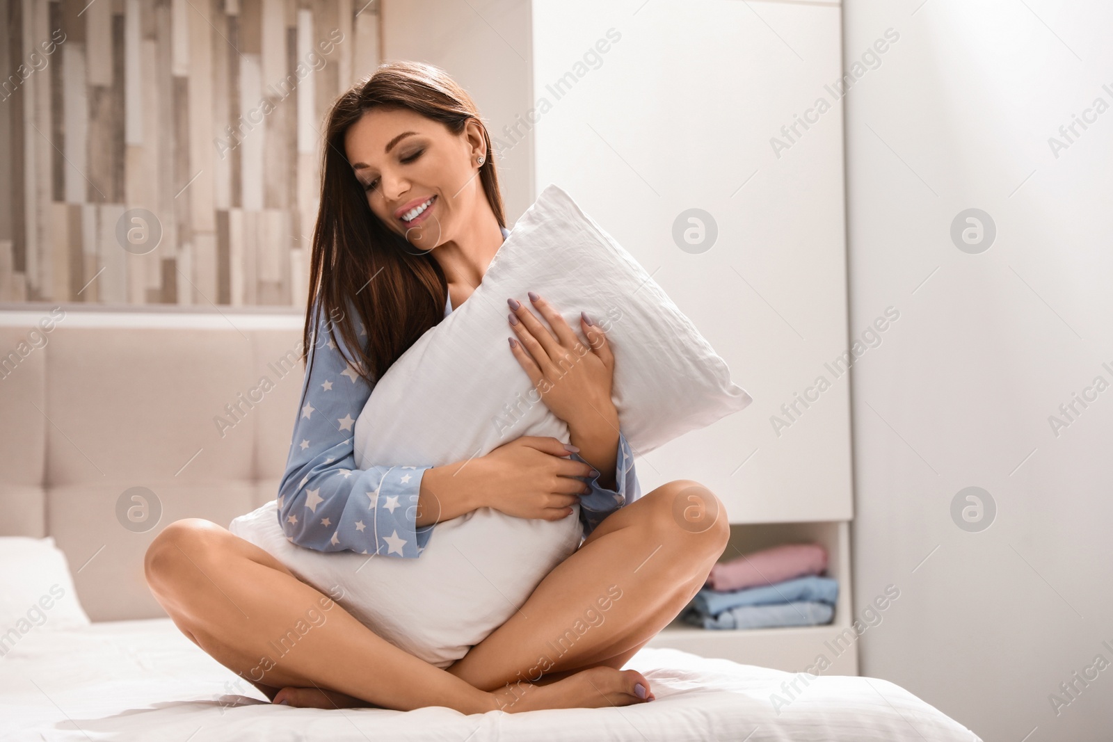 Photo of Beautiful woman with soft pillow at home. Bedtime