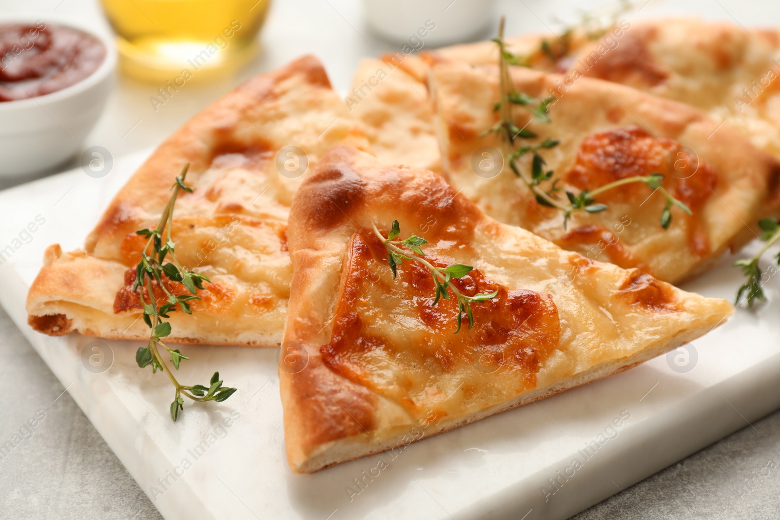 Photo of Delicious khachapuri with cheese on white board, closeup