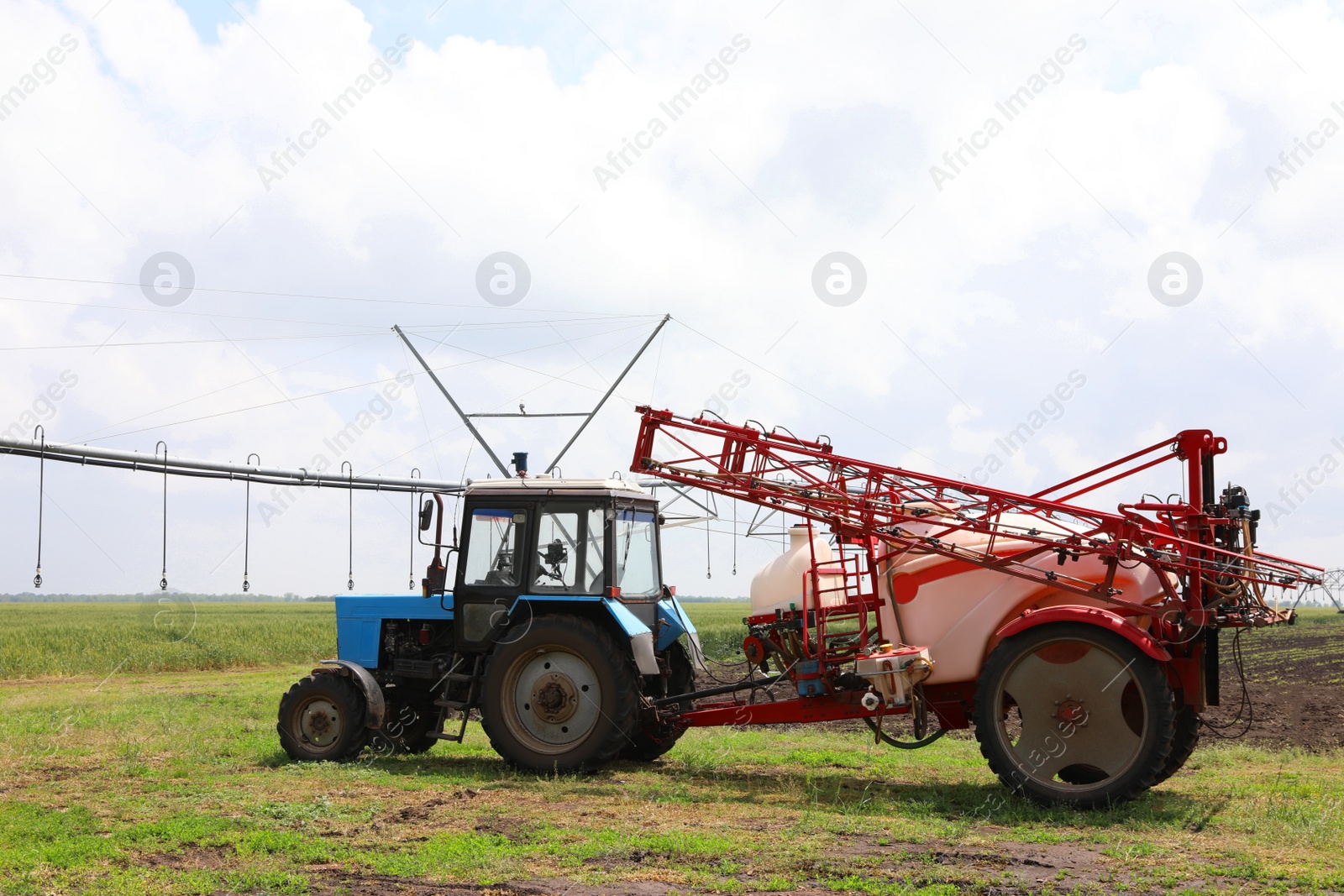 Photo of Modern agricultural equipment in field under cloudy sky