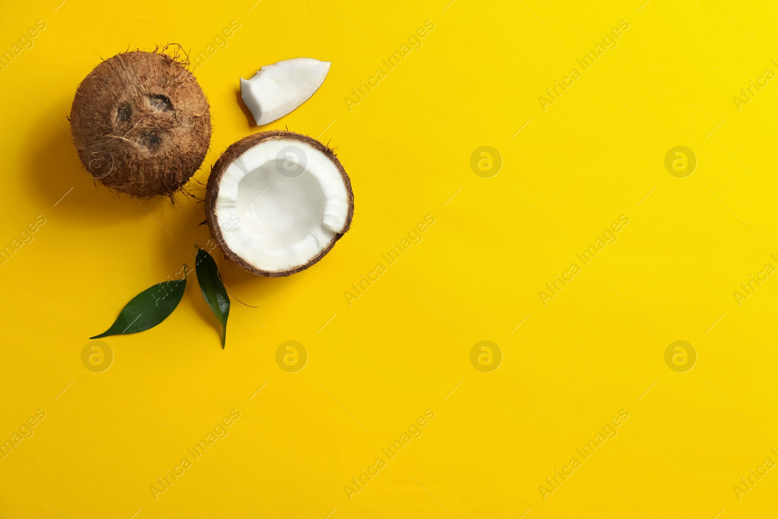 Photo of Flat lay composition with coconuts on color background. Space for text