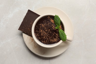 Photo of Cup of delicious hot chocolate with fresh mint on grey table, top view