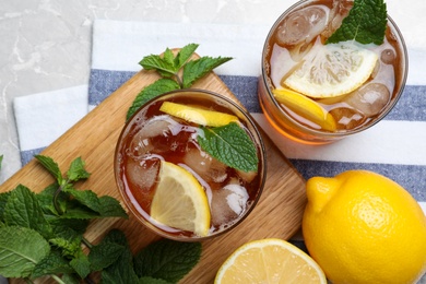 Photo of Delicious iced tea on light grey marble table, flat lay