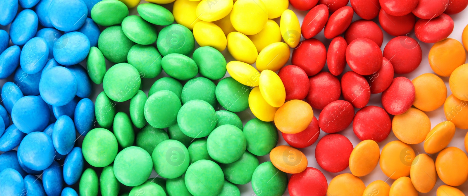 Image of Many colorful candies as background, top view. Banner design 