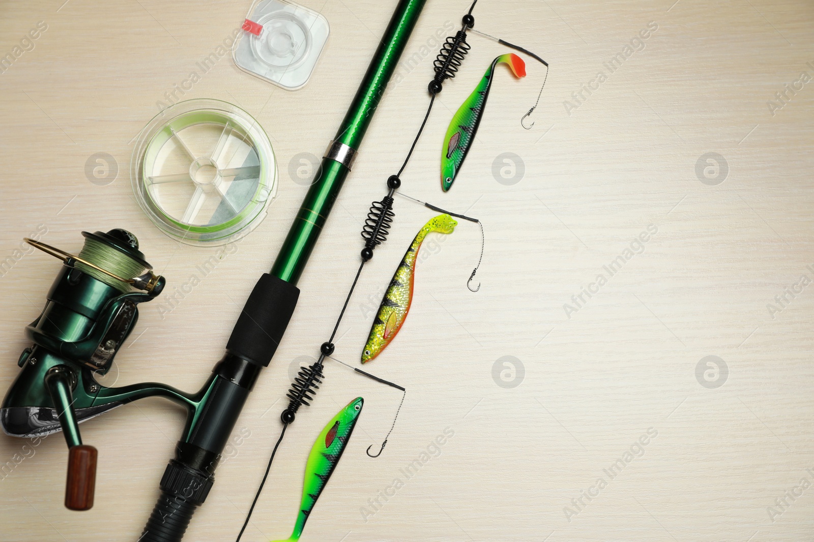 Photo of Fishing tackle on wooden background, flat lay. Space for text
