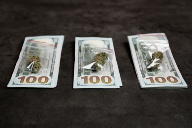 Photo of Money and plastic bags with hemp buds on grey background
