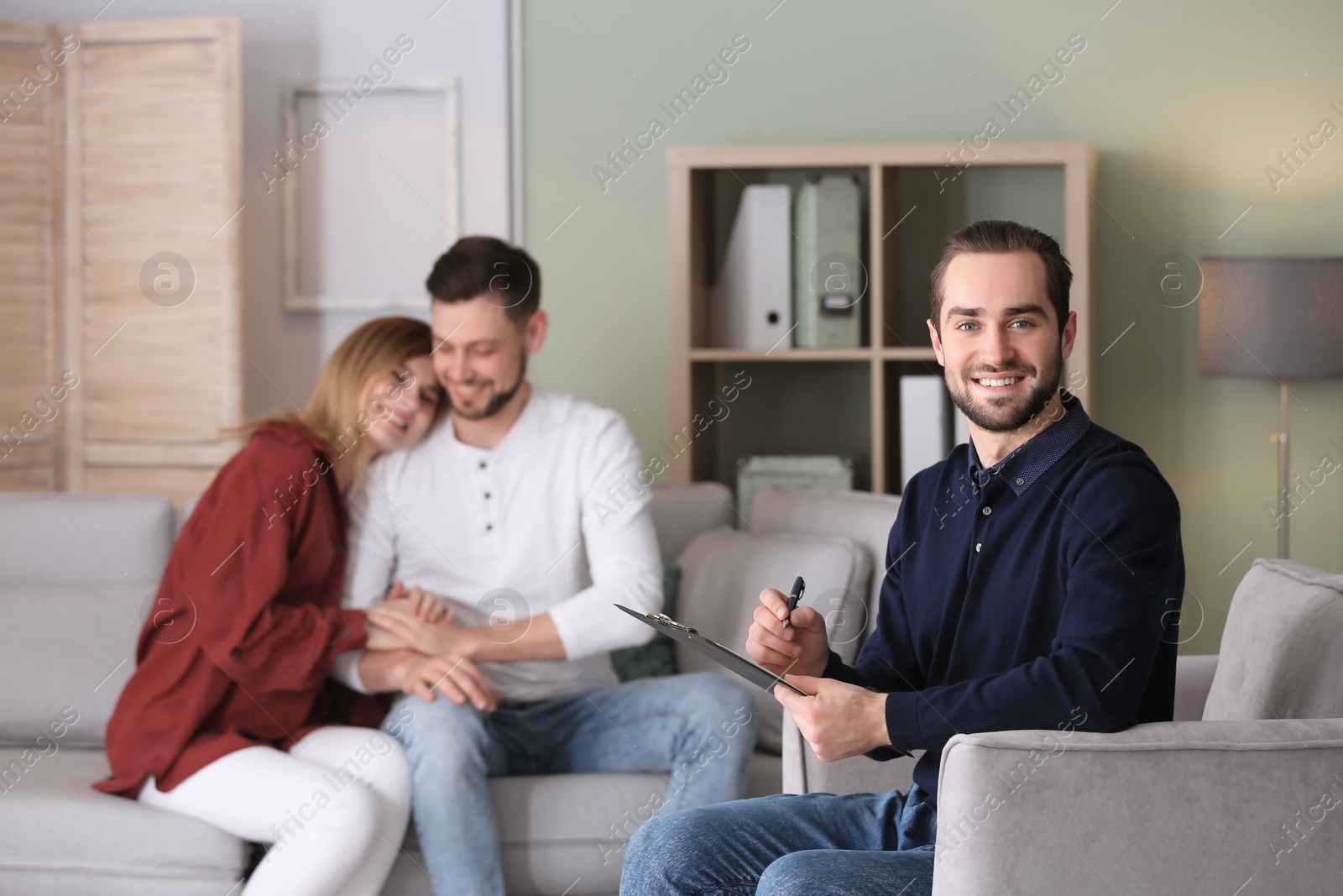 Photo of Professional psychologist and young couple in office