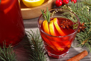 Photo of Aromatic punch drink and Christmas decor on wooden table