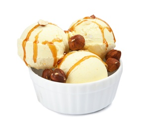 Photo of Delicious ice cream with caramel sauce and hazelnuts in dessert bowl on white background