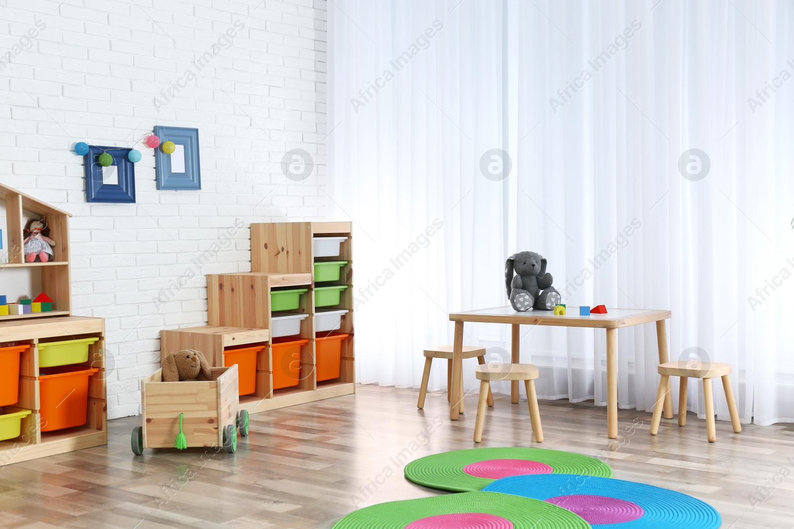 Photo of Modern child room interior with table and stools