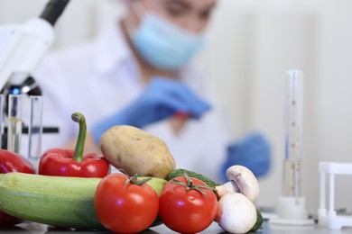 Photo of Fresh vegetables on table in laboratory. Food quality control