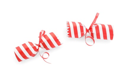 Open striped Christmas cracker isolated on white, top view