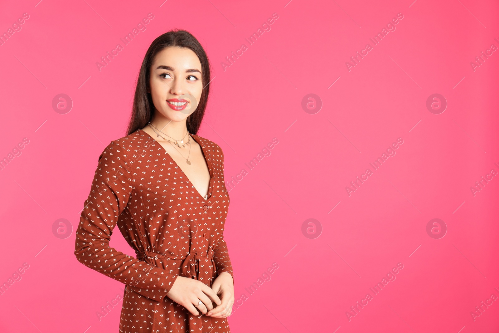 Photo of Portrait of beautiful young woman in stylish dress on color background. Space for text