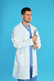 Doctor in uniform with clipboard on blue background