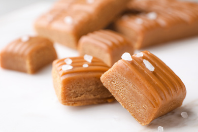 Photo of Salted caramel on white table, closeup view