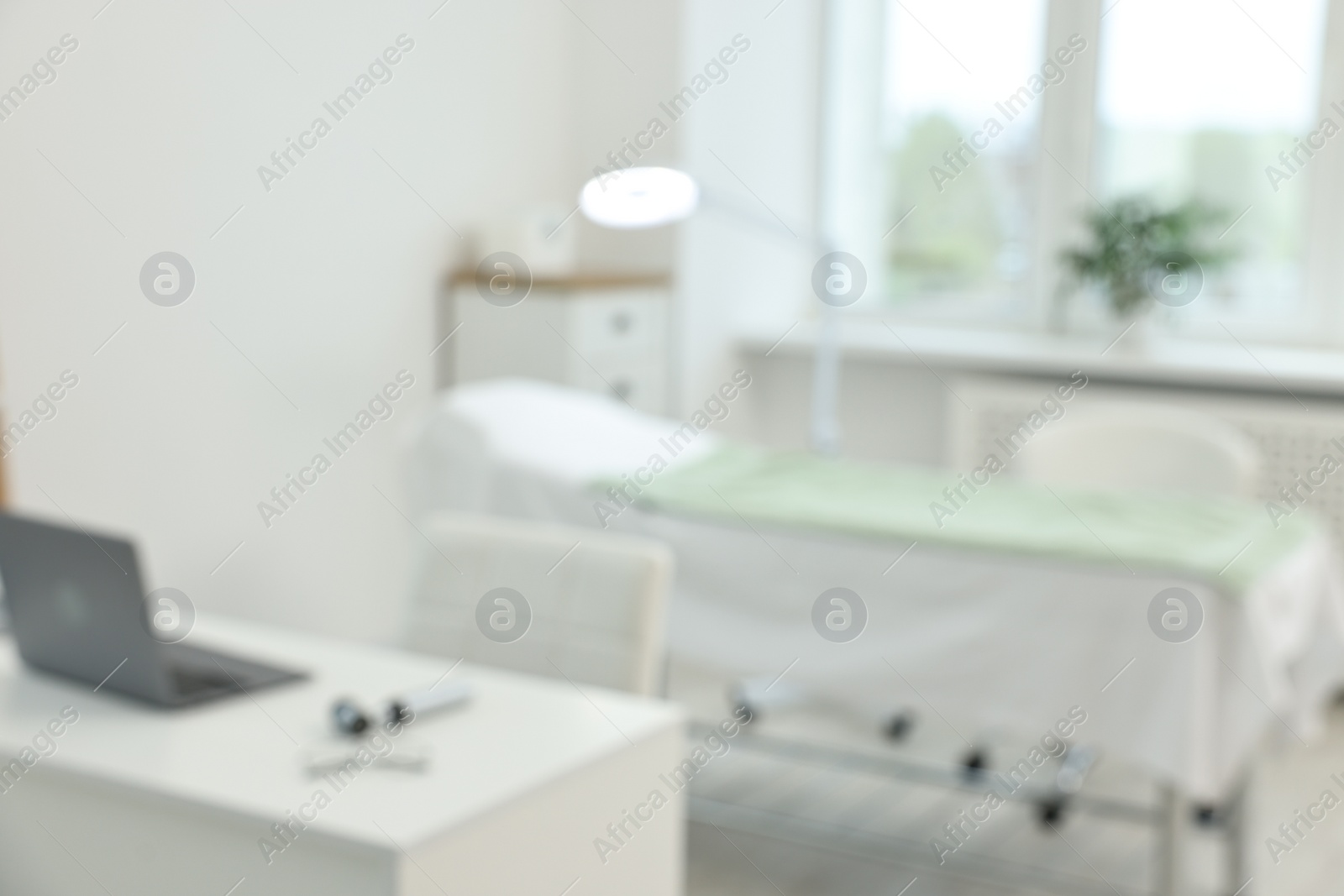 Photo of Modern interior of dermatologist's office with examination table