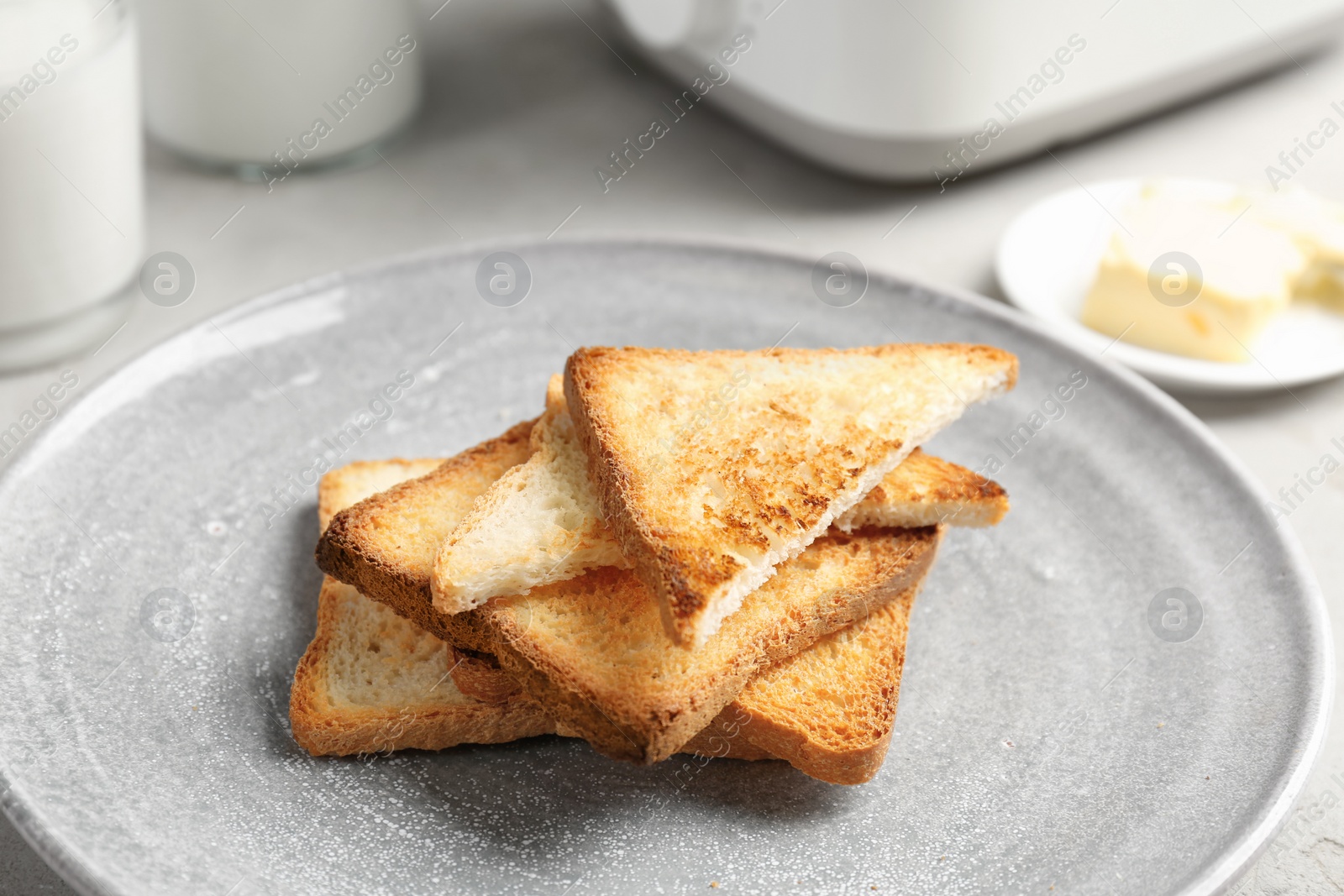 Photo of Plate with toasted bread on table, closeup