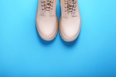 Photo of Pair of stylish leather shoes on light blue background, flat lay. Space for text