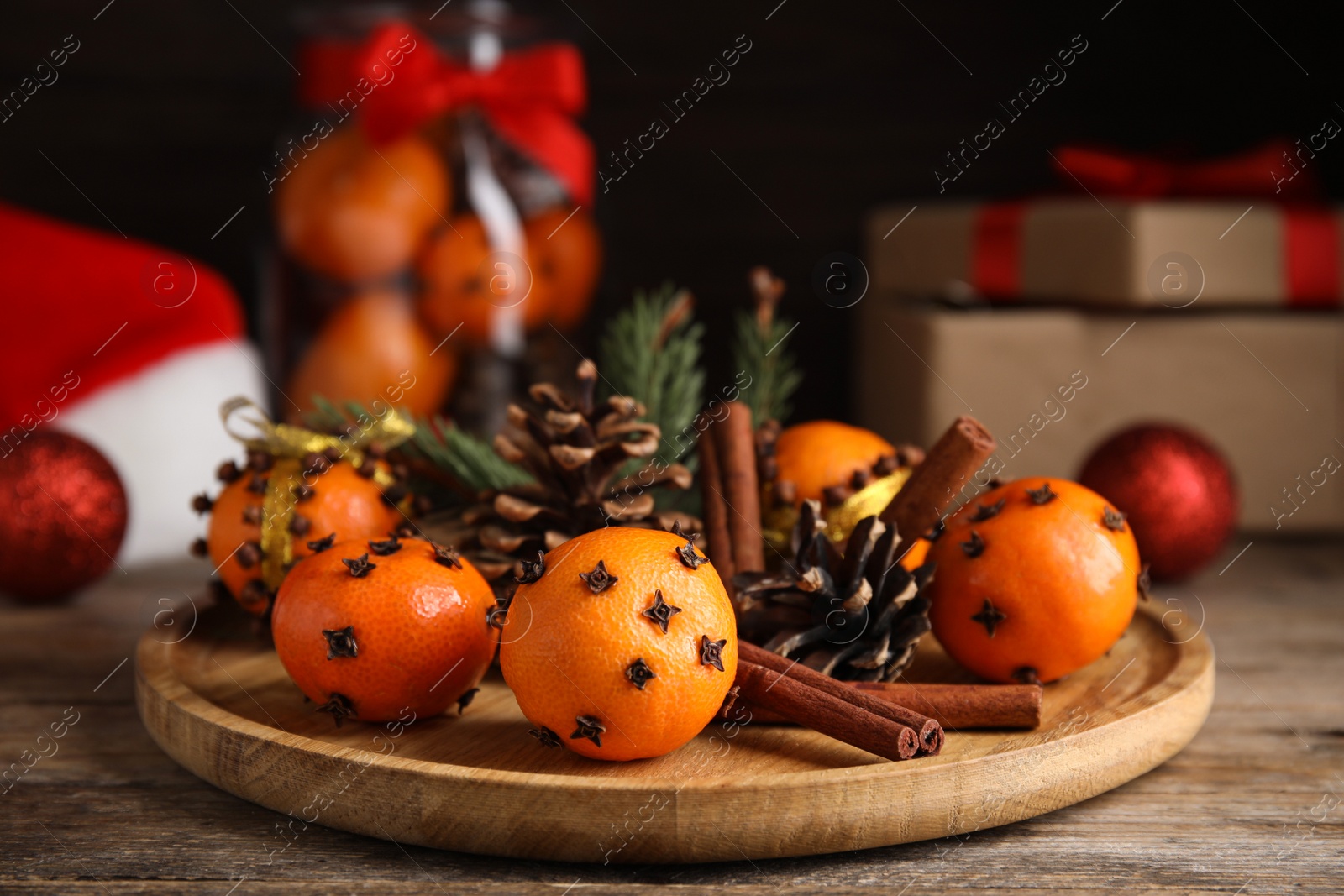 Photo of Christmas composition with tangerine pomander balls on wooden table