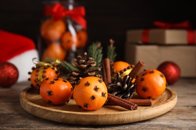 Christmas composition with tangerine pomander balls on wooden table