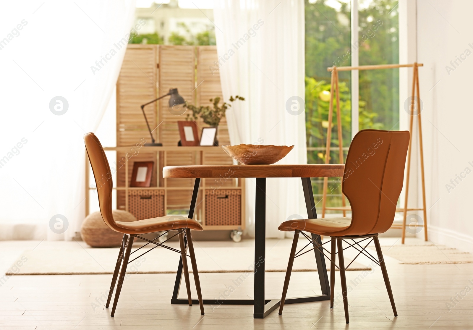 Photo of Modern dining room interior with table and chairs