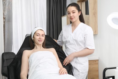 Photo of Portrait of cosmetologist and patient in clinic
