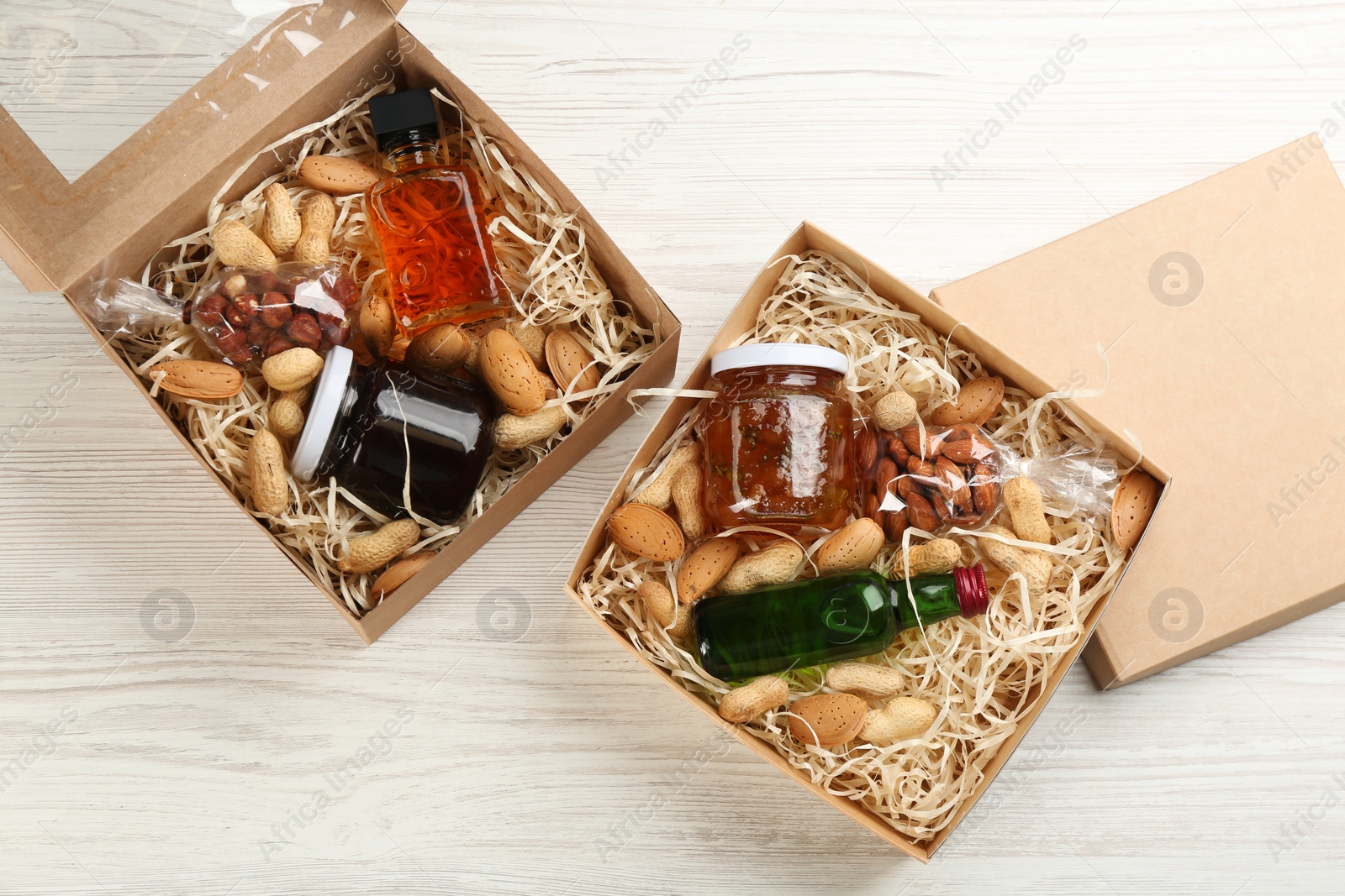 Photo of Stylish gift sets on white wooden table, flat lay