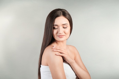 Portrait of beautiful woman on grey background. Cosmetology and spa