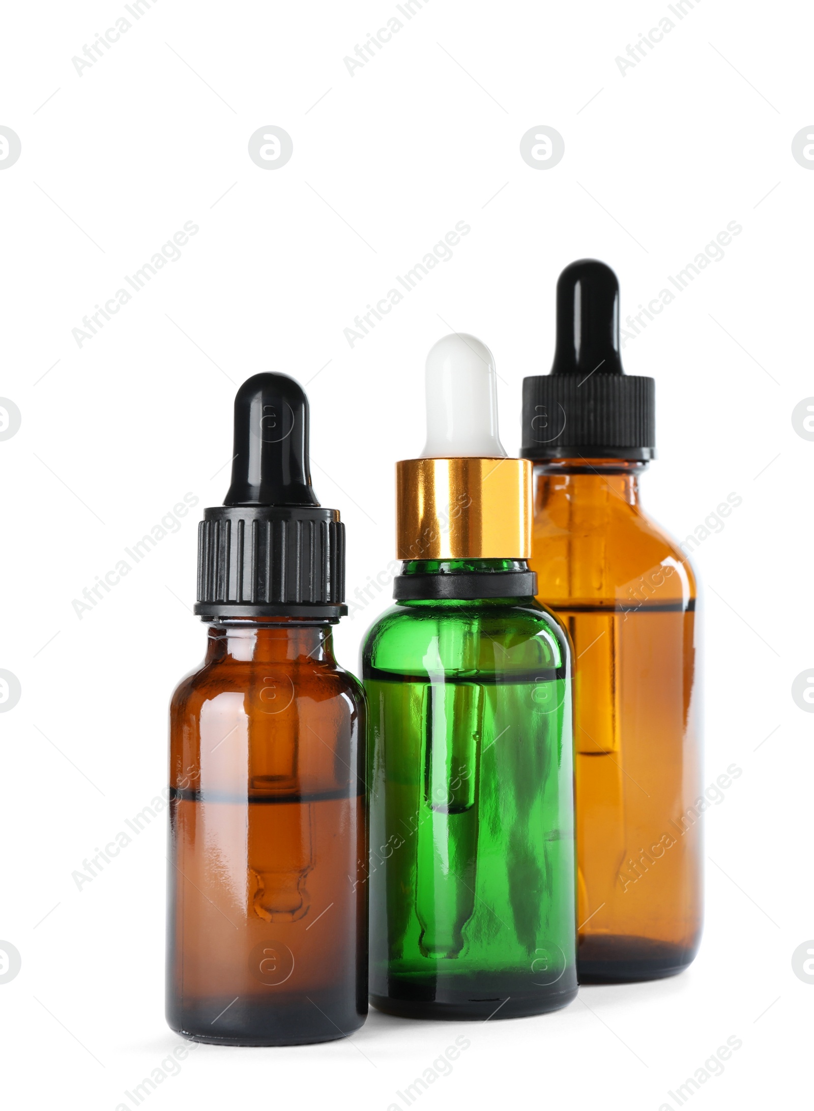 Photo of Bottles of herbal essential oils isolated on white