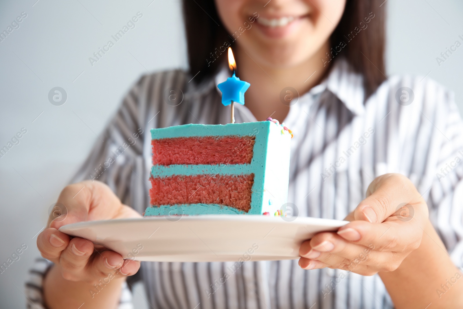 Photo of Woman holding fresh delicious birthday cake with candle, closeup