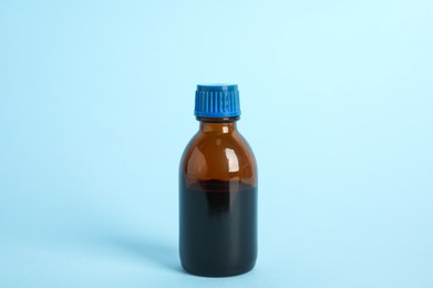 Photo of Bottle of medical iodine on light blue background