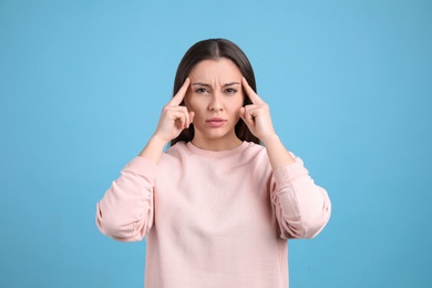 Photo of Portrait of stressed young woman on light blue background