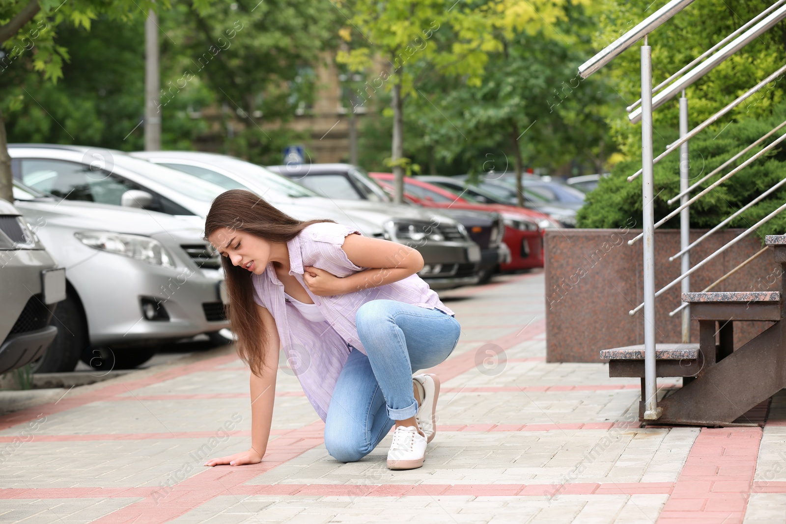 Photo of Young woman having chest pain outdoors. Heart attack