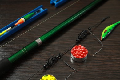 Photo of Fishing tackle on dark wooden background, closeup