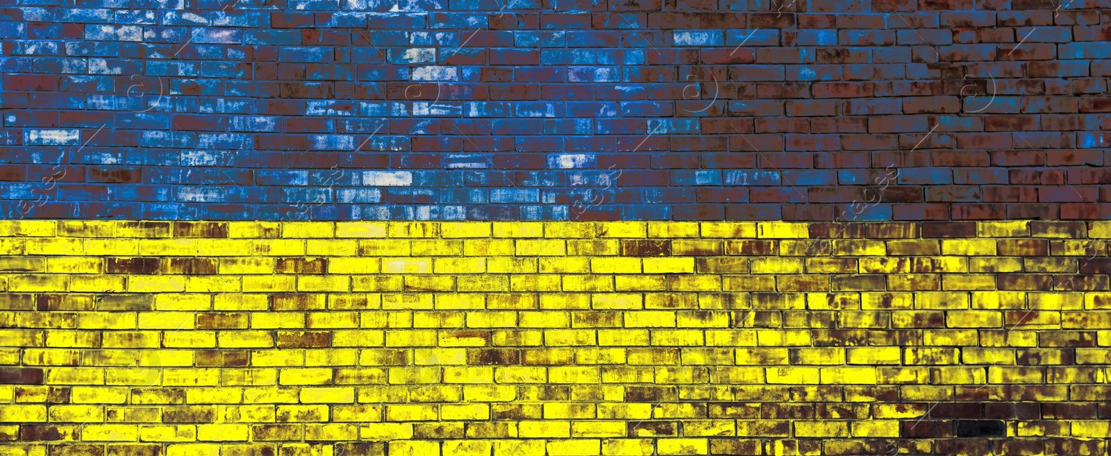 Image of National flag of Ukraine painted on brick wall, banner design