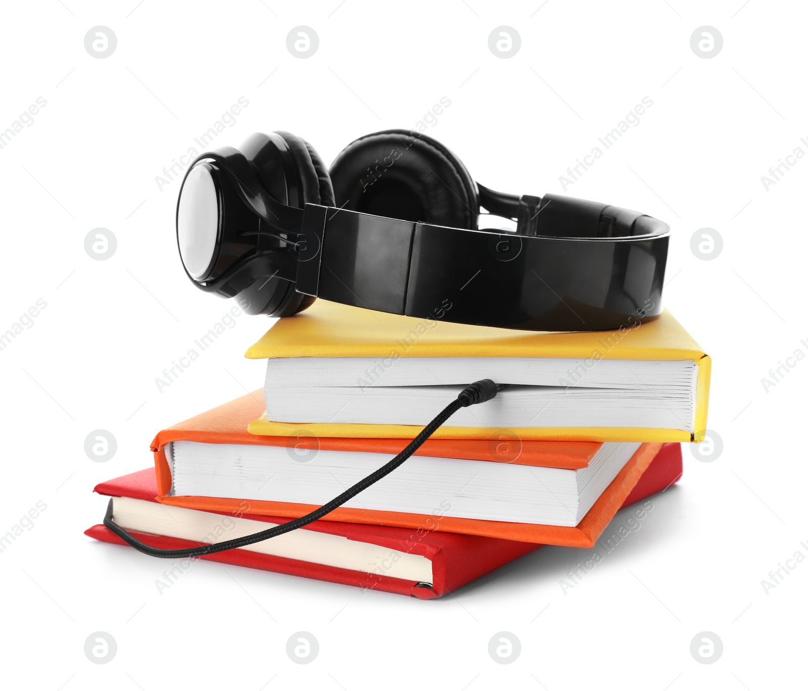 Photo of Modern headphones with hardcover books on white background