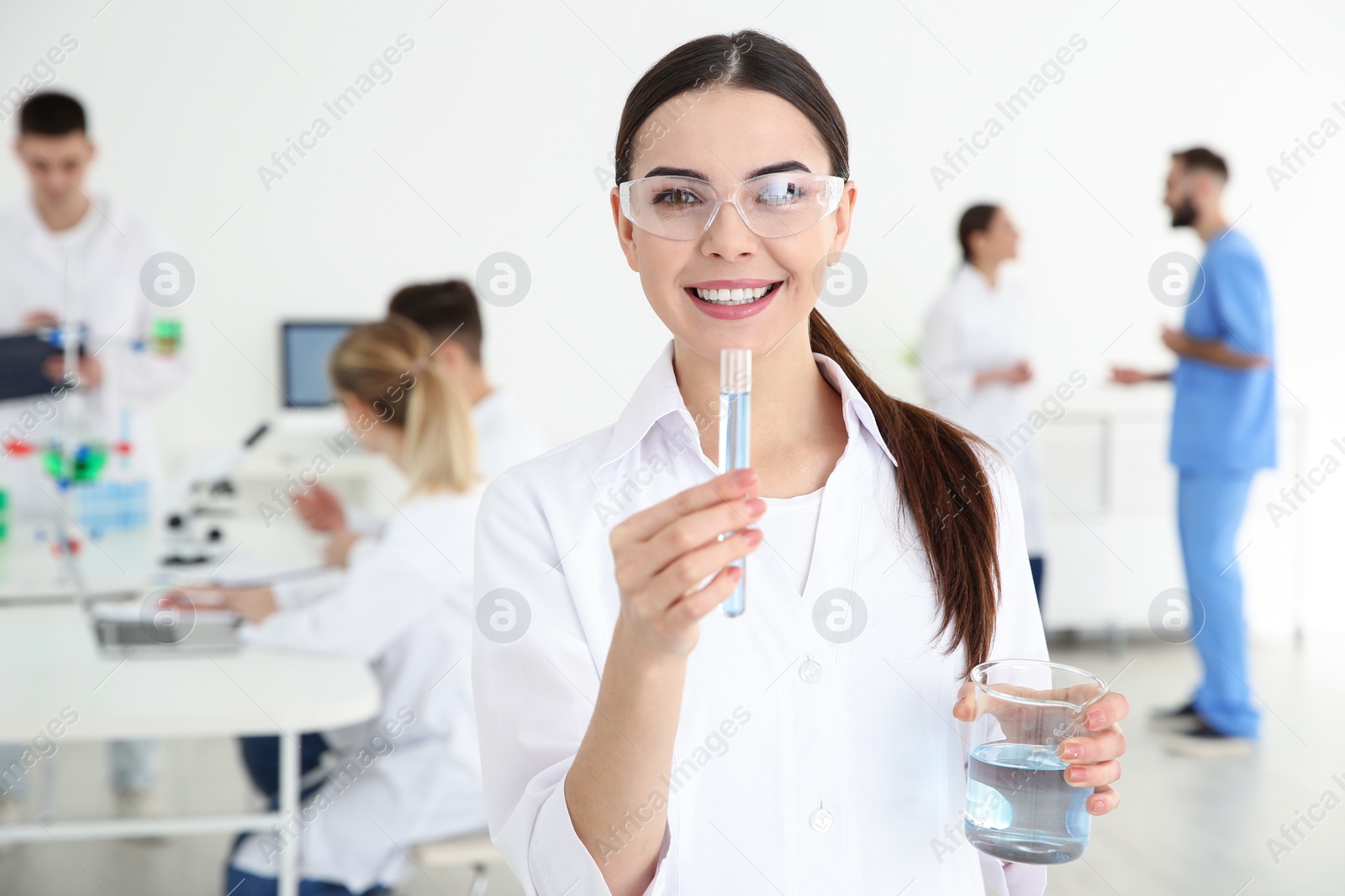 Photo of Portrait of medical student with test tube and beaker in modern scientific laboratory