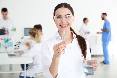 Photo of Portrait of medical student with test tube and beaker in modern scientific laboratory