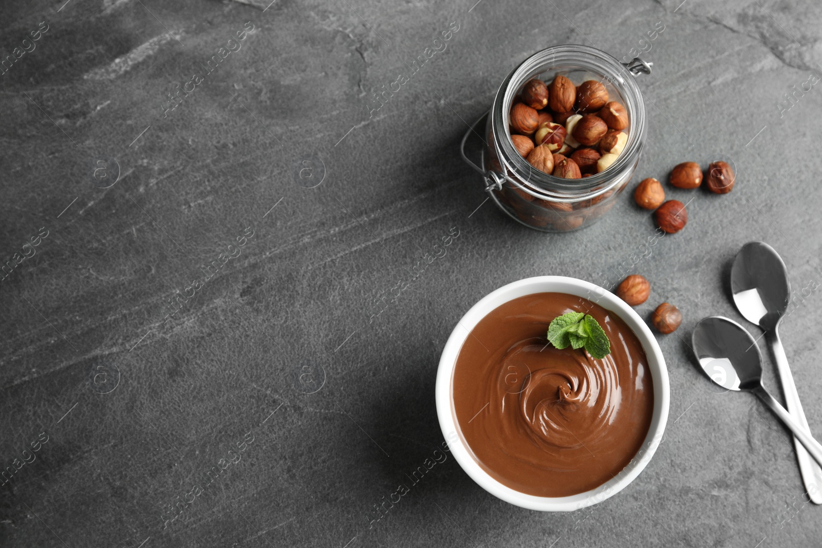 Photo of Flat lay composition with tasty chocolate mousse and space for text on table