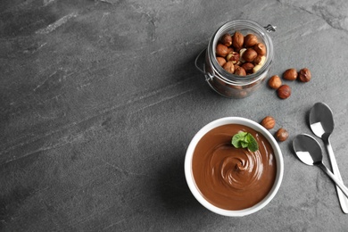 Photo of Flat lay composition with tasty chocolate mousse and space for text on table