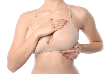 Woman checking her breast on white background, closeup