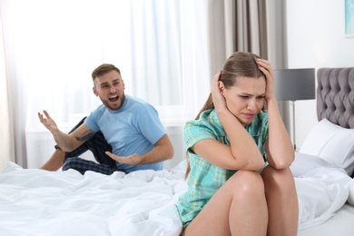 Young couple arguing in bedroom. Relationship problems